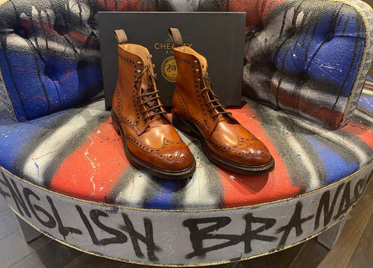 Cheaney tan leather brogue boots with Joseph Cheaney & Sons box on a red, white and blue English Brands graffiti chair